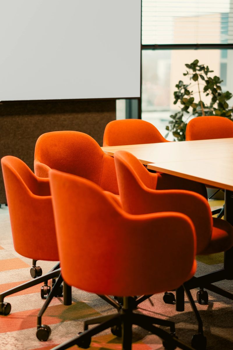 Meeting room empty board seating interior. Corporate conference environment featuring modern upholstered chairs surrounding large table creating professional atmosphere suitable executive discussion strategy planning governance presentation decisionmaking