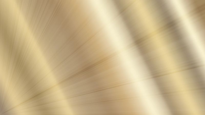 gold metal texture abstract background metallic shiny surface steel foil pattern with elegant light rays and glowing effect with copy space for banner design concept of jewelry, luxury, finance.