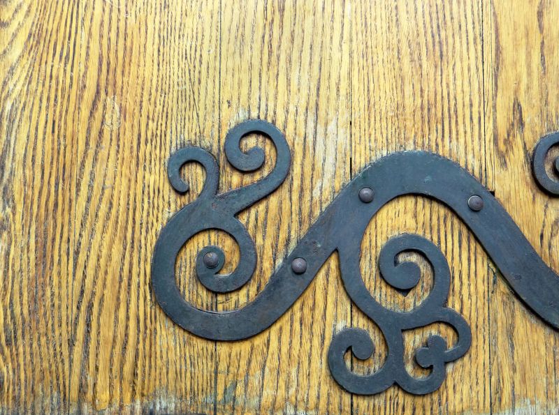 Old oak door with metal ornament.