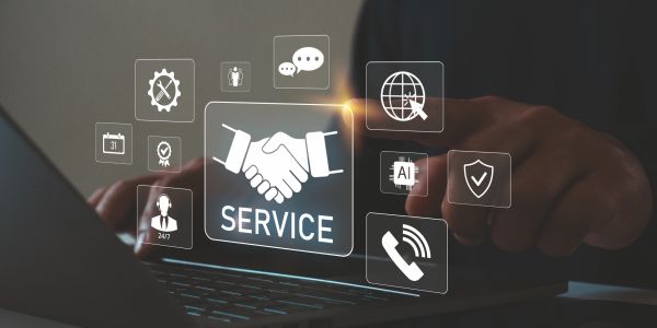 Digital service concept with handshake and technology icons over laptop.