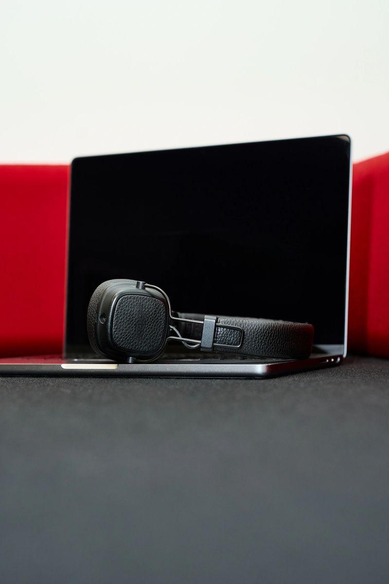 Professional workspace featuring a sleek laptop and headphones, ideal for technology, innovation, and productivity concepts