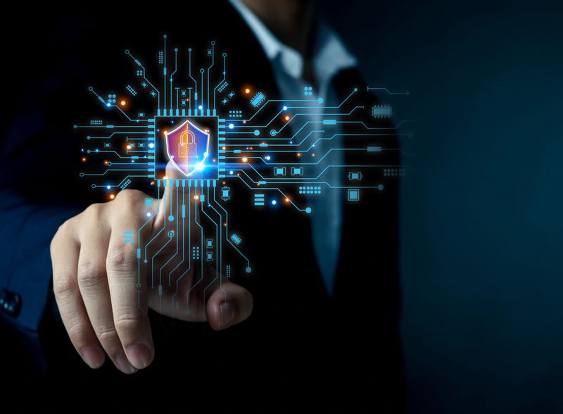 Cyber security concept with businessman touching digital shield and lock icon on virtual interface. Technology protection, data privacy, network security and information safety for business finance.