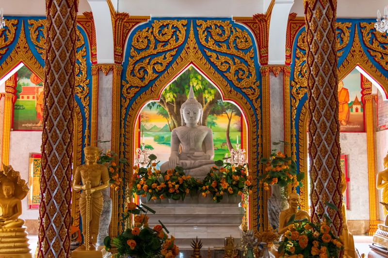 A stunning view of a magnificent Buddhist temple showcases its golden statues and intricate patterns beautifully