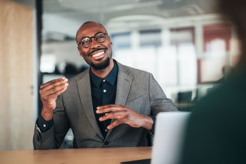 Legal advisor meeting with a client in a modern office to provide professional legal consultation and guidance. The scene represents legal services, trust, client confidentiality, professional advice, and problem solving in a law office environment
