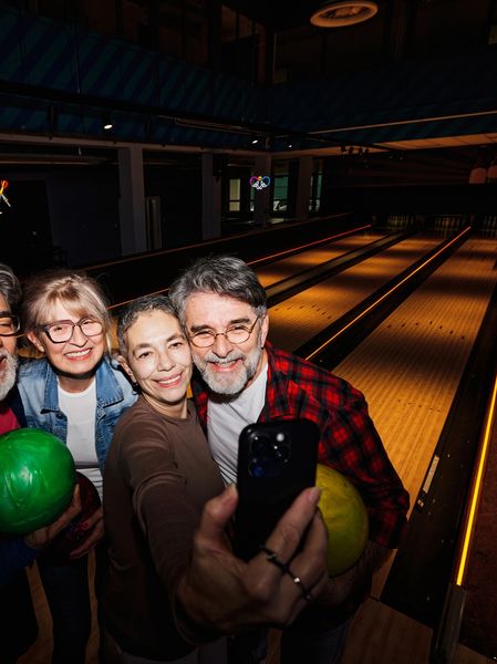 Group of friends taking a selfie at a bowling alley.