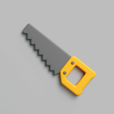 Toy saw with a yellow handle on a gray background.