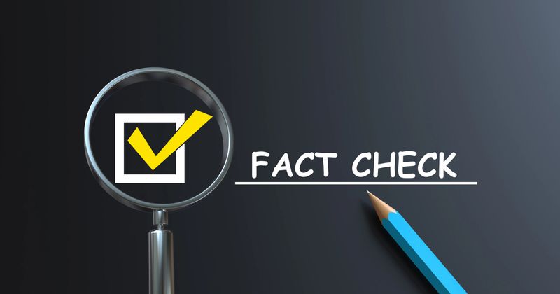 Check mark and fact check text in a magnifying glass with pencil Chalkboard
