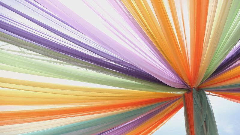 Vibrant fabric drapes forming a cheerful canopy, symbolizing cultural festivity and design