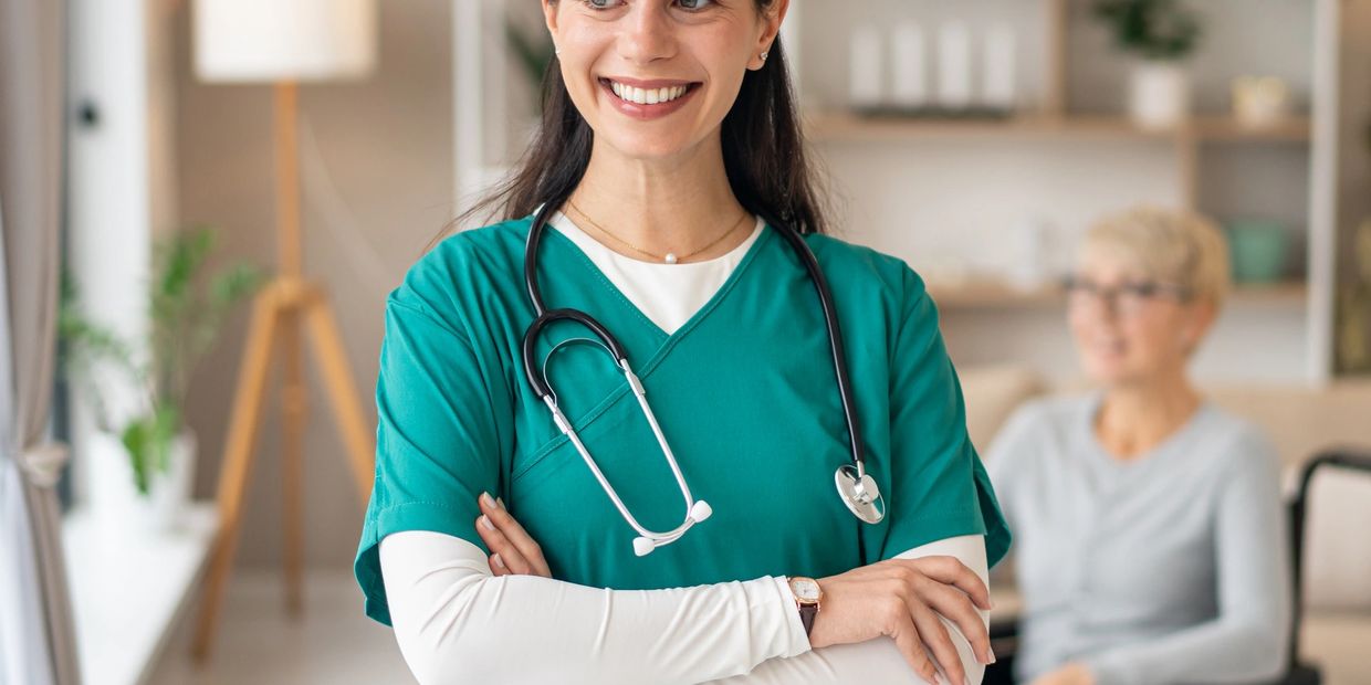 Smiling nurse with stethoscope in medical facility.