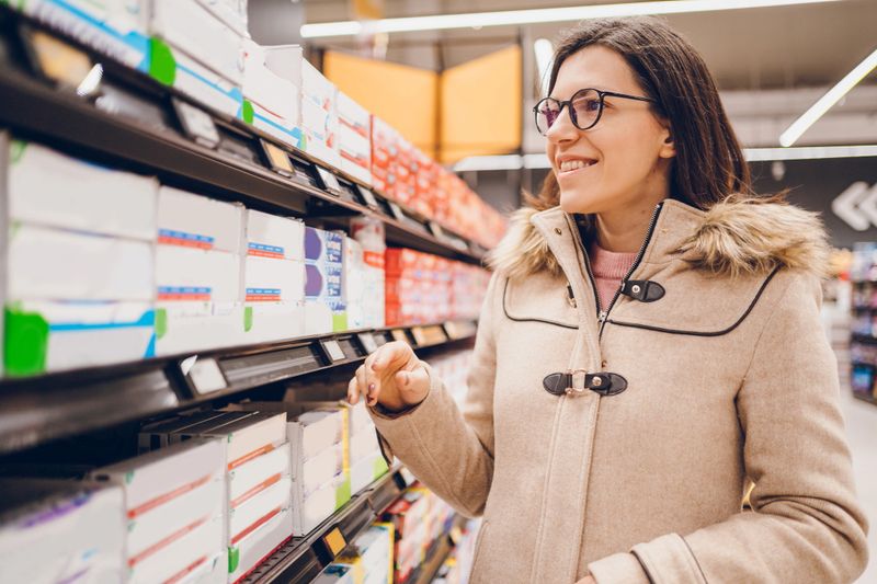 Beautiful woman buying toothpaste.
