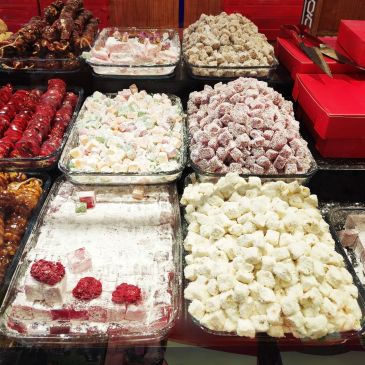 Assorted colorful Turkish delights in glass trays.