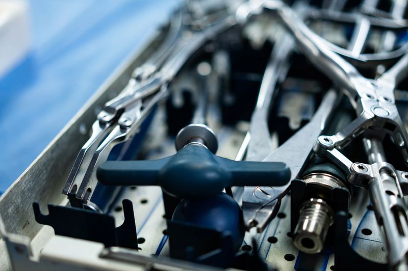 Workshop tools and equipment. Various mechanical tools are organized on a metal tray in a workshop, highlighting precision and craftsmanship.