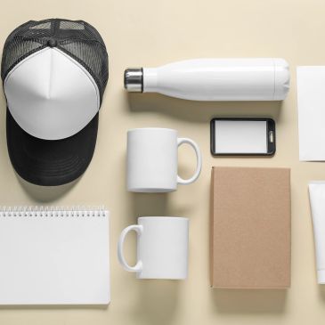 Flat lay of blank promotional items on beige background.