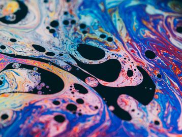 Colorful abstract fluid pattern with bubbles.