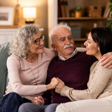 Adult daughter spending time with her senior parents at home.