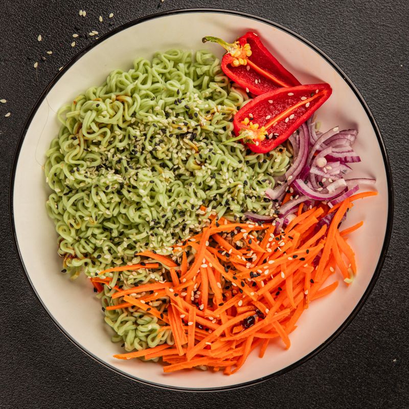 vegetarian noodles jade noodles with vegetables green noodles healthy food budha bowl main course appetizer fresh delicious gourmet food table background rustic food top view copy space
