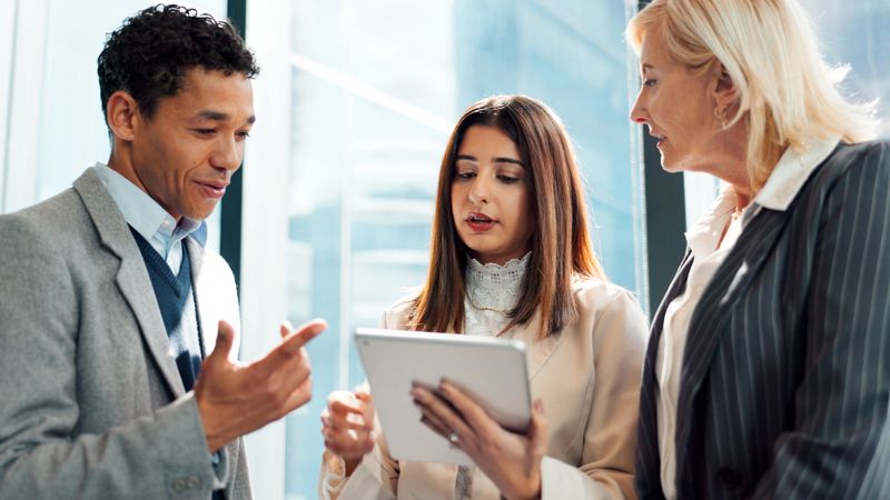 Business people, lawyer or conversation in office with tablet for advocacy, legal case or manager advice. Team, tech and discussion with attorney management for lawsuit plan, legislation or feedback.