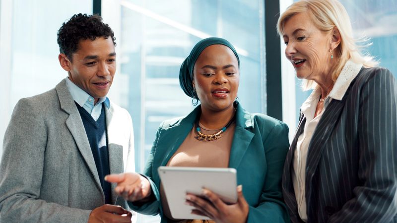 Tablet, business people and lawyer in office with talk for advocacy, legal case and manager advice. Team, tech or communication with attorney management for lawsuit planning, feedback or legislation.