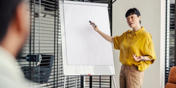 Woman giving a presentation using a flip chart.