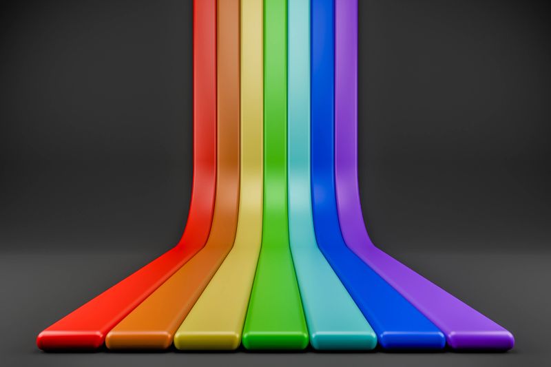 Dynamic rainbow lines descending onto a dark reflective ground surface.