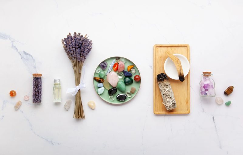 Chakra Crystal Healing Ritual With Lavender Palo Santo White Sage Essential Oils And Candles On White Marble Background