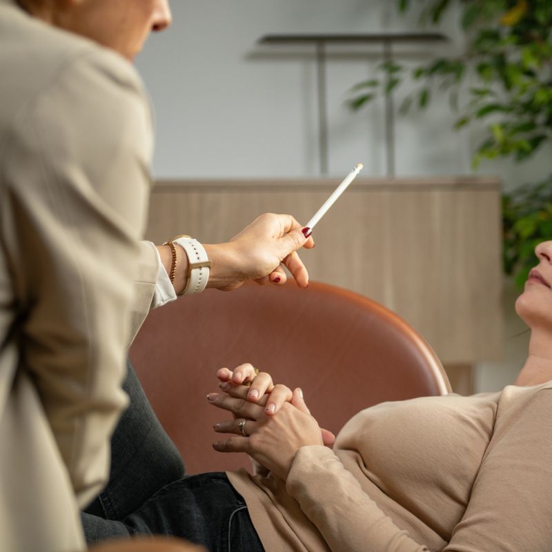 Hypnosis session where therapist uses pen movement to direct attention and induce relaxation. Emphasizes visual tracking, calm engagement, and therapeutic control.