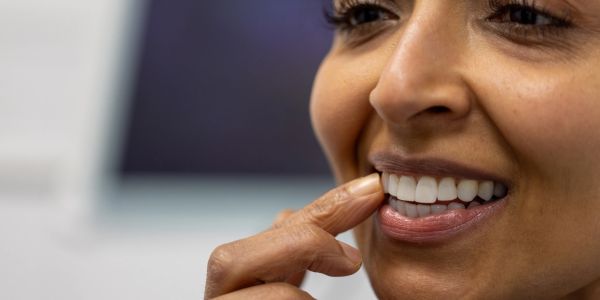 Close-up of a smiling woman showing her teeth.
