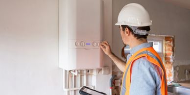 Technician inspecting a boiler unit.