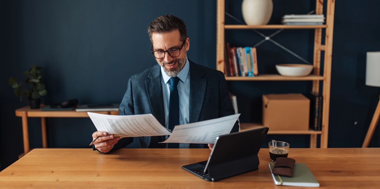 accountant frustrated looking at a pile of documents