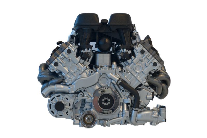 A detailed front view of a highperformance V8 engine showcasing its cylinders, intake system, exhaust headers, and mechanical components, creating a dynamic technical composition ideal for automotive, engineering, and mechanicaldesign themes.