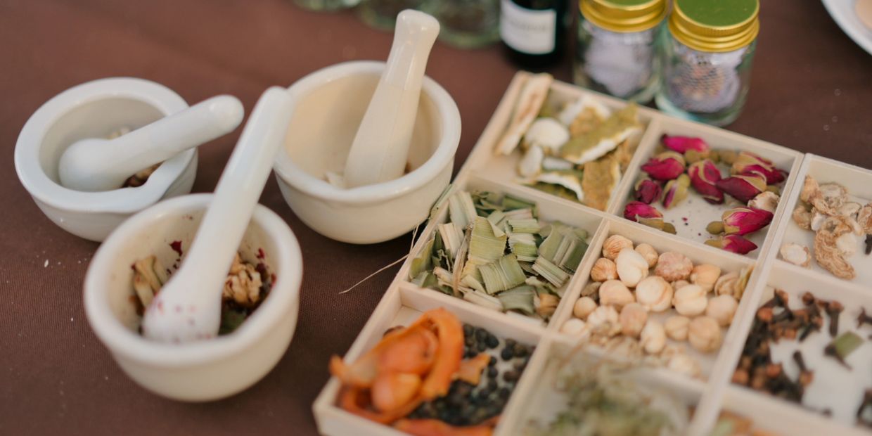 Mortar and pestle with various herbs and spices.