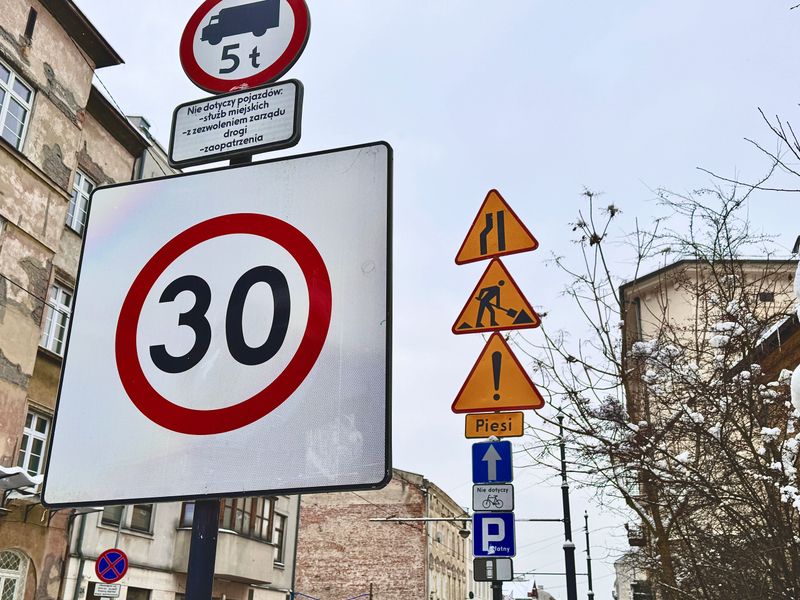 A variety of different road signs on a city street at Krakow in Poland