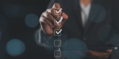 Person checking off boxes on a digital interface.