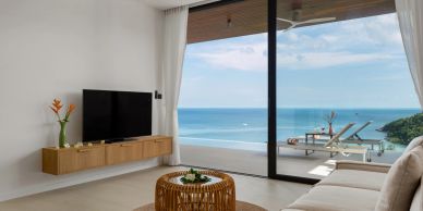 Modern living room with ocean view and balcony.