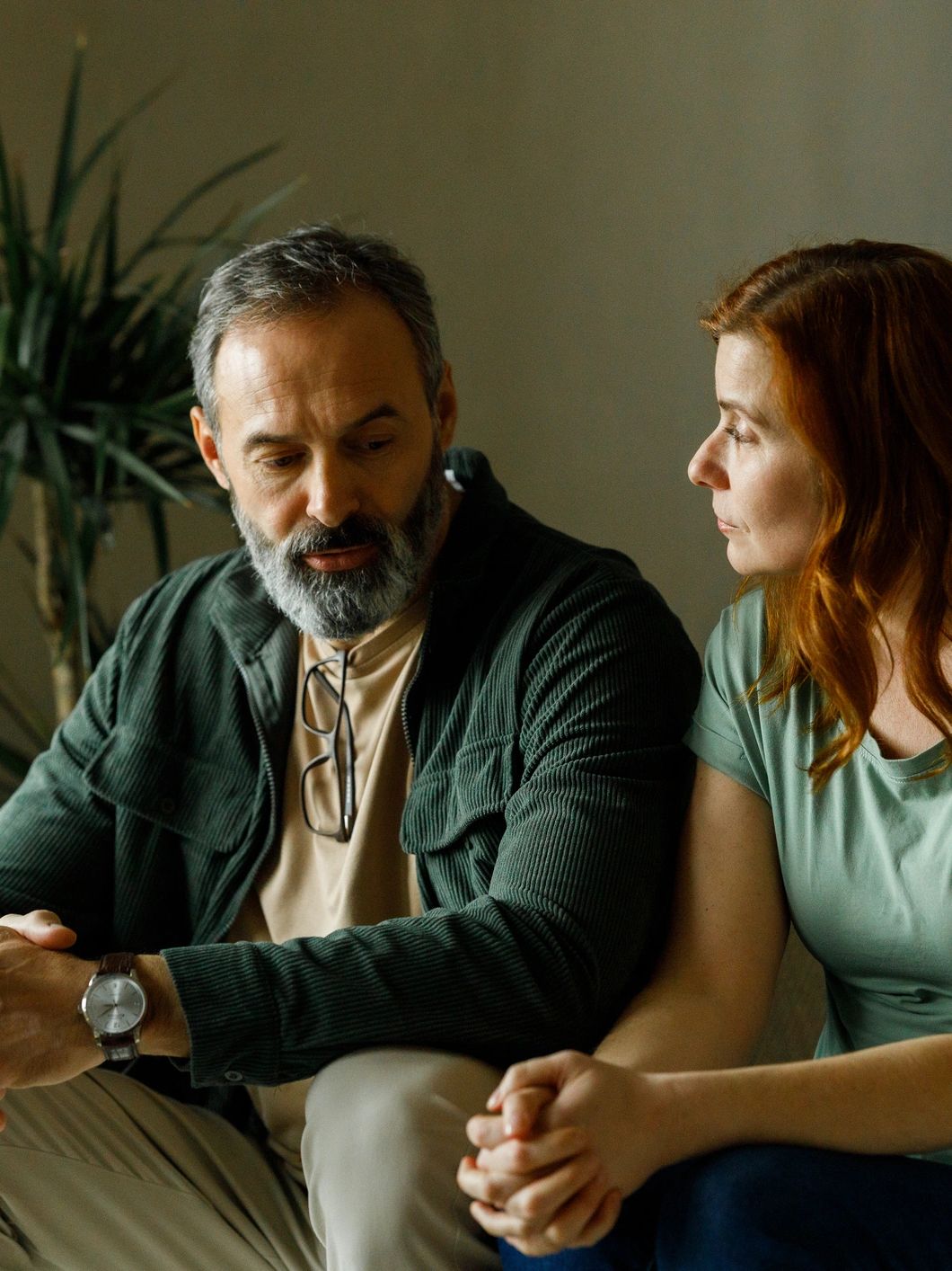 A serious conversation between a man and a woman indoors.