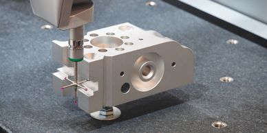 Machining precision metal part with measurement probe.