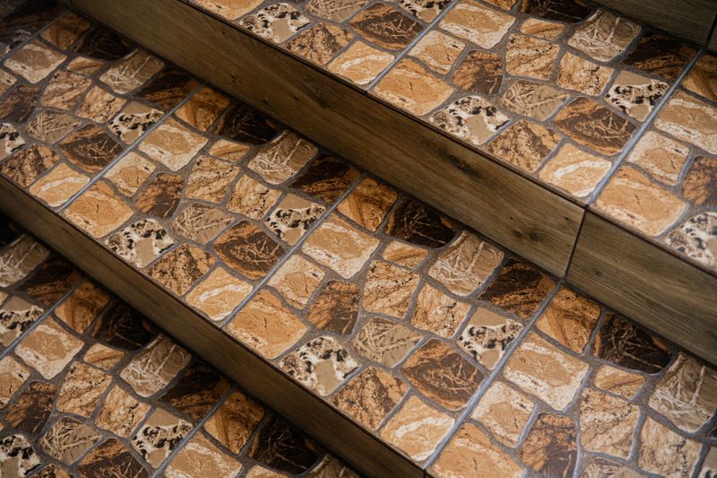 Rustic tile staircase with brown and beige stone pattern for flooring and home design concept