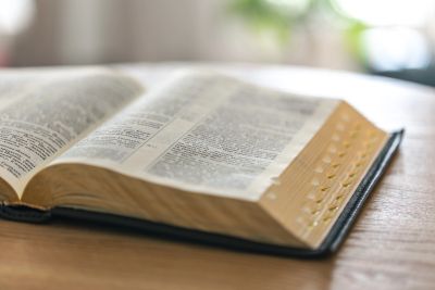 Open Bible on a wooden table.