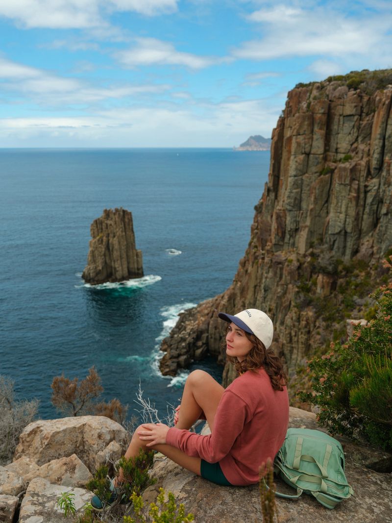 Determined Gen-Z woman  hiking on Tasman Peninsula in Tasmania in summer.  Cape Hauy