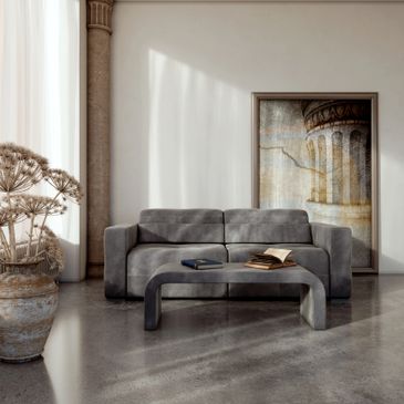 Minimalist living room with a gray sofa, modern coffee table, and large framed artwork.