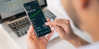 Person using a smartphone for stock trading.