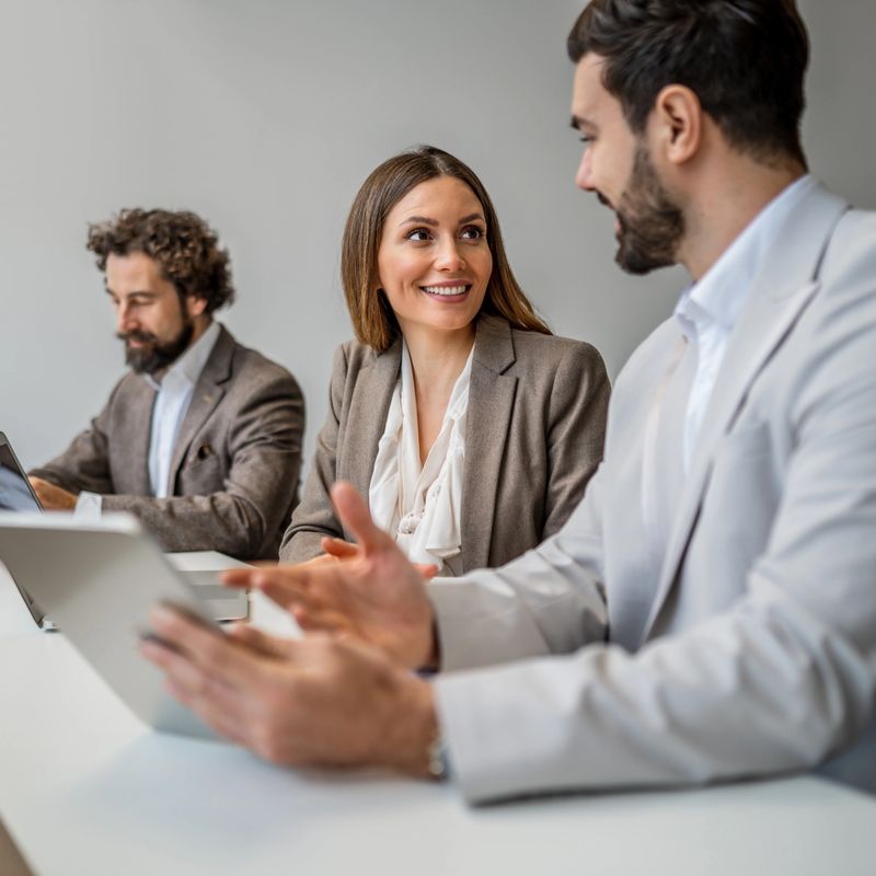 Business people discussing ideas and strategy in a modern office, fostering collaboration and communication among team members