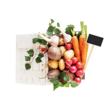 A white crate filled with fresh vegetables and a small blank chalkboard.