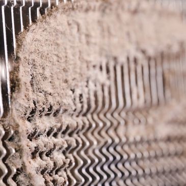 Close-up of a dusty, dirty air filter.