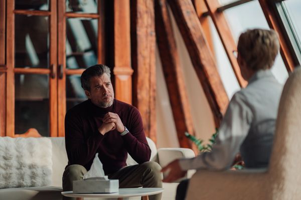 Man attentively listening during a therapy session.