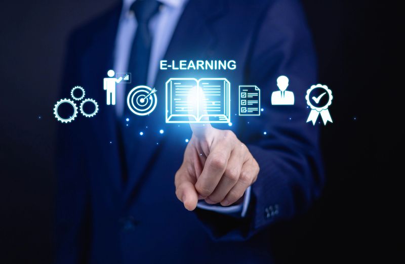 Businessman presenting online education and digital learning icons including graduation cap, analytics, target and global network. E learning, training, skill development and business growth concept.