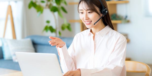 Young woman video calling with headphones on.