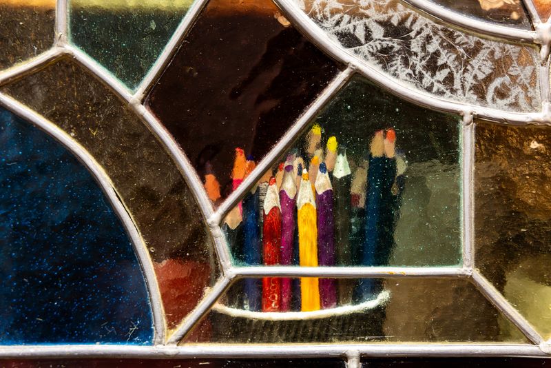 Artistic View of Colored Pencils Through Multi-Colored Stained Glass Window