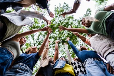 Group of people putting their hands together in a circle.