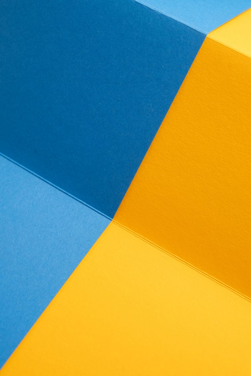 Geometric Paper Folds in Bold Blue and Yellow Tones. Minimalist Abstract Background
